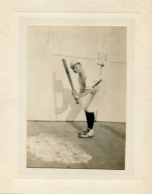 Boy Holding a Bat with Base Ball Shoes